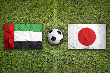 Image showing United Arab Emirates vs. Japan flags on soccer field