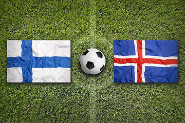 Image showing Finland vs. Iceland flags on soccer field
