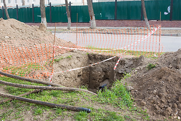 Image showing Dug pit fenced for replacing electric cables underground