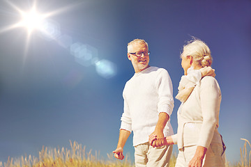 Image showing happy senior couple talking outdoors