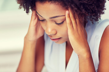 Image showing close up of african young woman touching her head