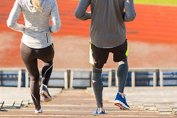 Image showing close up of couple running downstairs on stadium