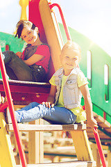 Image showing happy kids or children on playground slide