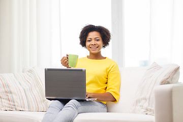 Image showing happy african american woman with laptop at home