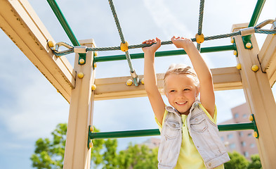 Image showing happy little girl climbing on children playground