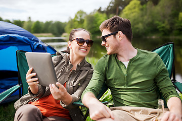 Image showing happy couple with tablet pc at camping tent