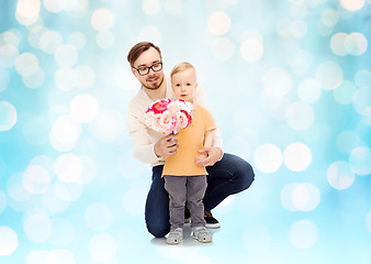 Image showing happy father and son with bunch of flowers