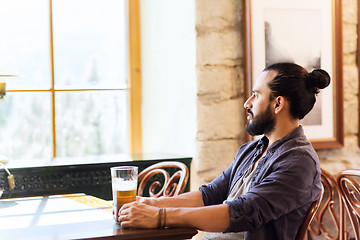 Image showing happy man drinking beer at bar or pub