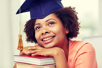 Image showing happy african bachelor girl with books at home