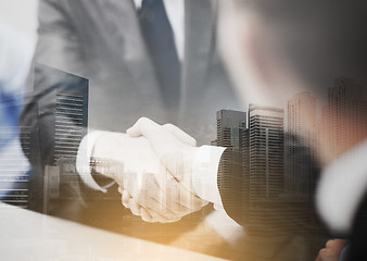 Image showing two businessmen shaking hands in office