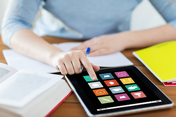 Image showing close up of student with menu icons on tablet pc