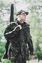 Image showing young soldier or hunter with gun in forest