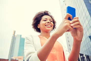 Image showing happy african businesswoman with smartphone