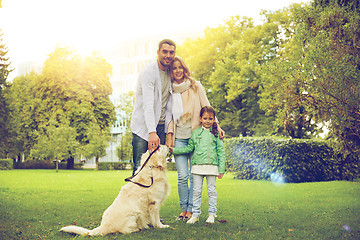 Image showing happy family with labrador retriever dog in park