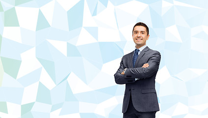 Image showing smiling businessman over blue low poly texture