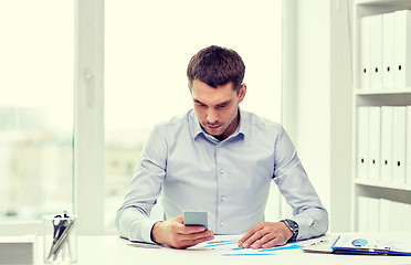 Image showing close up of businessman with smartphone