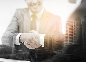 Image showing two businessmen shaking hands in office