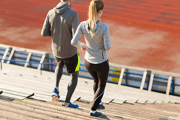 Image showing couple running downstairs on stadium