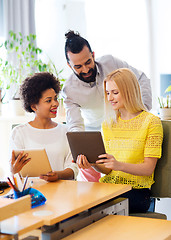 Image showing happy creative team with tablet pc in office