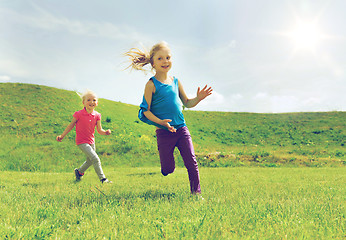Image showing group of happy kids running outdoors