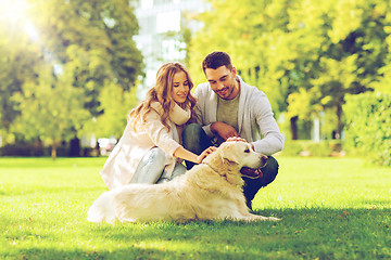 Image showing happy couple with labrador dog walking in city