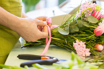 Image showing close up of florist man with bunch at flower shop