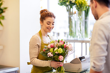 Image showing smiling florist woman and man at flower shop