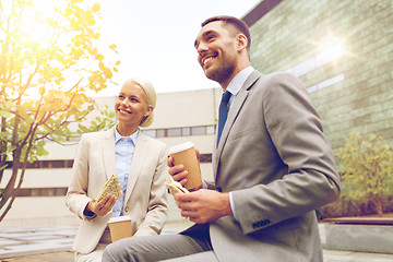 Image showing smiling businessmen with paper cups outdoors