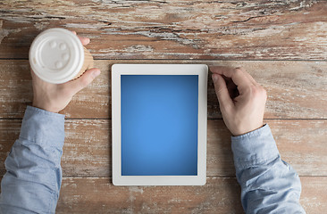 Image showing close up of male hands with tablet pc and coffee