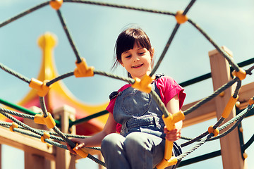 Image showing happy little girl climbing on children playground