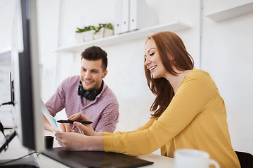 Image showing happy creative team with papers at office