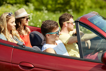 Image showing happy friends driving in cabriolet car