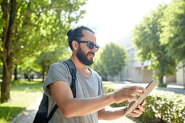 Image showing man traveling with backpack and tablet pc in city