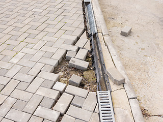 Image showing The destruction of the pedestrian walkway of paving with drainage and concrete road