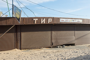 Image showing Vityazevo, Russia - March 7, 2016: meadow covered pavilion with a broken roller shutters and the signboard \