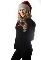 Image showing Woman in santa hat holding glass of white wine