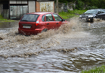 Image showing Car rides in heavy rain on a flooded road