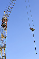 Image showing Crane and building construction site against blue sky