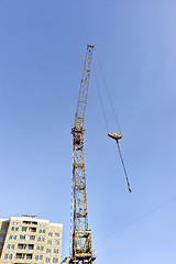 Image showing Crane and building construction site against blue sky