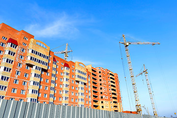 Image showing Crane and building construction site against blue sky