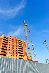 Image showing Crane and building construction site against blue sky