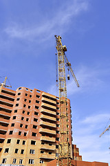 Image showing Crane and building construction site against blue sky