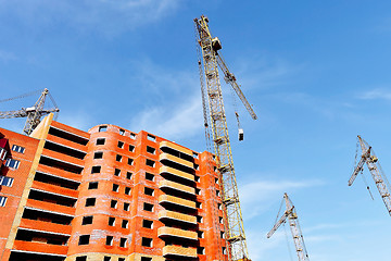 Image showing Crane and building construction site against blue sky