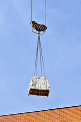 Image showing Crane and building construction site against blue sky