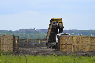 Image showing Big old tipper vith clay ground dumped soil in storage space