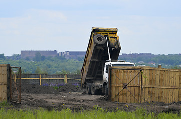 Image showing Big old tipper vith clay ground dumped soil in storage space