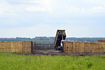 Image showing Big old tipper vith clay ground dumped soil in storage space