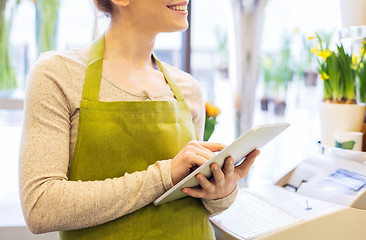 Image showing woman with tablet pc computer at flower shop