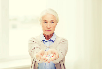 Image showing senior woman with medicine at home