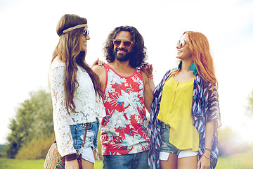 Image showing smiling young hippie friends talking outdoors